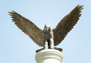 Eagle stone statue on blue sky