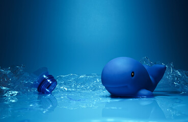 Arrangement of blue toy dolphin wrapped in plastic debris representing ocean environmental problems