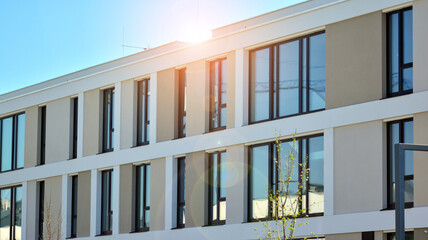 Apartment residential house and home facade architecture and outdoor facilities. Blue sky on the background. Sunlight in sunrise.