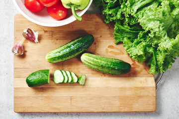 Fresh vegetables on a cutting board, salad ingredients.