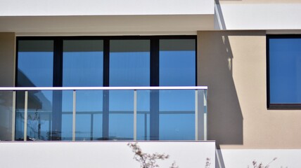 Condominium and apartment building with  symmetrical modern architecture. Detail in modern residential flat apartment building exterior. Fragment of new luxury house and home complex. 