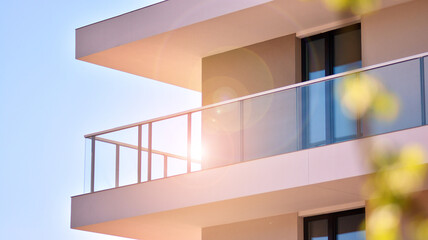 Apartment residential house and home facade architecture and outdoor facilities. Blue sky on the background. Sunlight in sunrise.