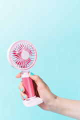 unknown person holding an electric fan
