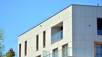 Condominium and apartment building with  symmetrical modern architecture. Detail in modern residential flat apartment building exterior. Fragment of new luxury house and home complex.