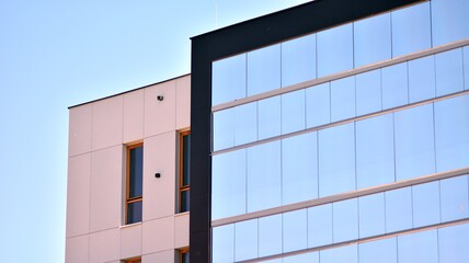 Condominium and apartment building with  symmetrical modern architecture. Detail in modern residential flat apartment building exterior. Fragment of new luxury house and home complex.