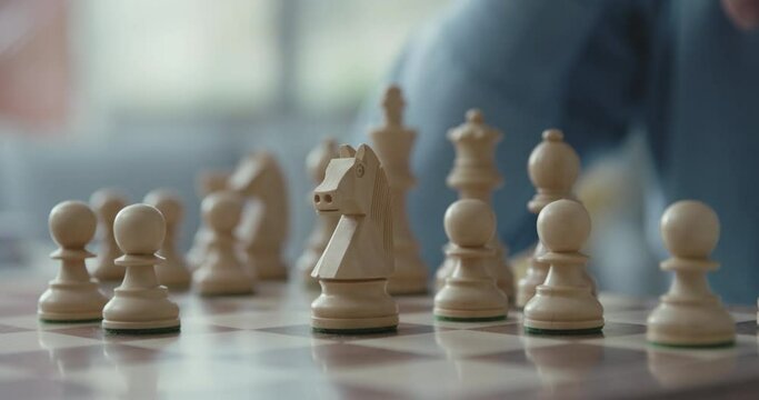 Senior man playing chess at home