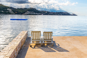 Two beach chairs, Piran town , Slovenia view