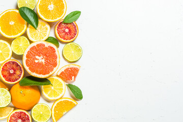 Citrus fruits at white background. Orange, lemon, lime, grapefruit with green leaves. Healthy food....