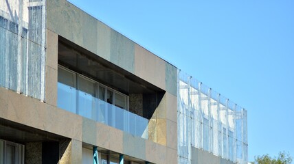 Glass facade of the buildings with a blue sky. Skyscrapers in the business city center.. Background of modern glass buildings. 