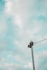 Lamp post under partly cloudy sky