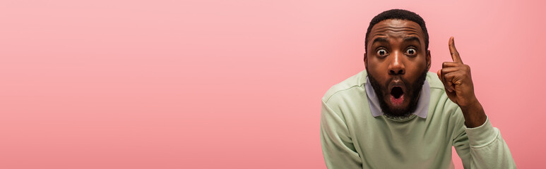 Excited african american man having idea isolated on pink, banner