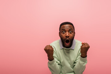 Excited african american man doing yes gesture isolated on pink