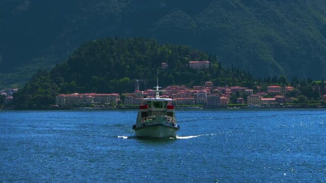 A suggestive boat crosses lake Como with Bellagio in the background.lake como.travel Italy.
