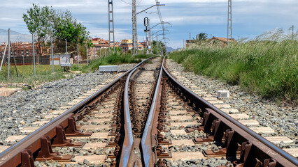 Railway near Valencia. Rails extending beyond the horizon with a blue sky background