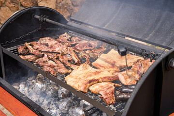 cooking on a charcoal and wood barbecue
