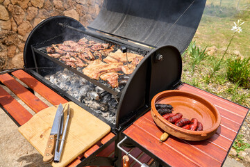 cooking on a charcoal and wood barbecue