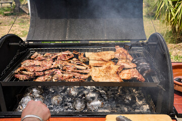 cooking on a charcoal and wood barbecue
