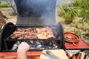 cooking on a charcoal and wood barbecue