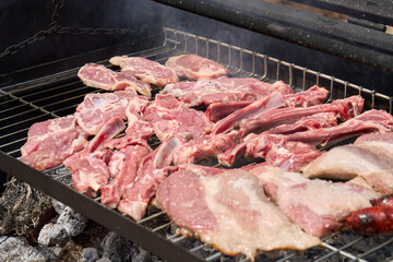 cooking on a charcoal and wood barbecue