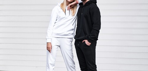 Pair of man and woman is wearing hooded sweatshirt. Copy space hoodie design for branding clothes
