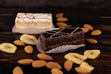 two cakes with black and white icing almonds and bananas
