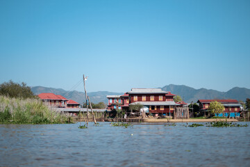 Fototapeta na wymiar Buildings by the riverside at Inle Lake, Myanmar