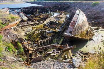 Ship graveyard. A sunken rusty abandoned fishing vessel in Russia, the Kola Peninsula, the Barents Sea, Teriberka.