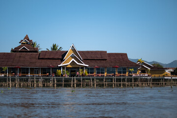 Fototapeta premium A big yellow house on the riverside in Inle Lake, Myanmar
