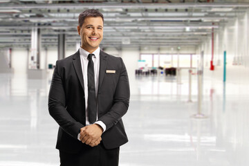 Airport official in a suit and tie posing - obrazy, fototapety, plakaty