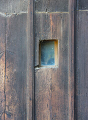 Old vintage wooden door with small window in Koprivshtitsa,  Bulgaria