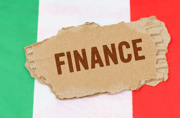 Against the background of the flag of Italy lies cardboard with the inscription - finance