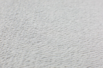 Grey cotton towel or carpet.fluffy texture background. Close up, macro photo. Soft focus image.