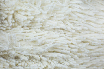 White cotton towel or carpet.fluffy texture background. Close up, macro photo. Soft focus image.