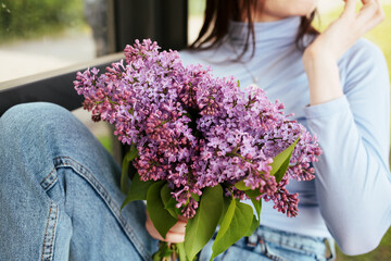 person with lilac flowers