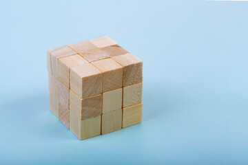 Obraz premium Wood Cube Block Construction on blue Background