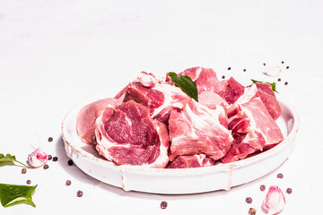 Diced raw pork meat with dry sumac, fresh garlic, and basil leaves