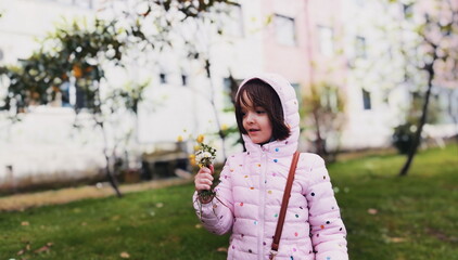 Little girl outside with the flowers