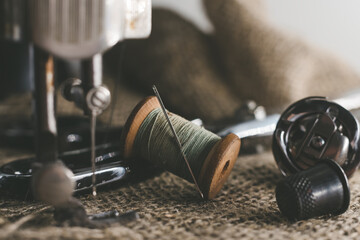 Needle and thread, scissors, sewing machine. Tailor's, fashion designer's, and seamstress's tools. Retro Sewing Tools