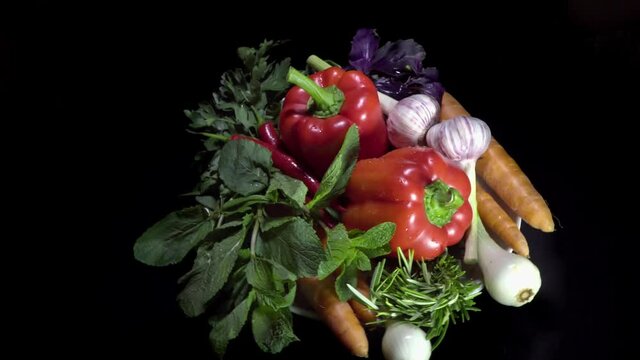 Vegetarian healthy food, vegetables:  salad, tomatoes ,peppers and others on a rotating plate