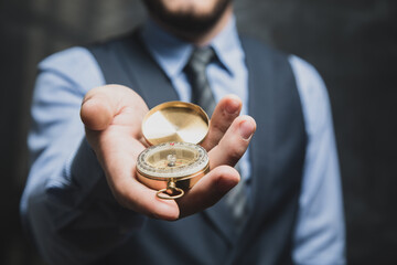 a man in a suit holding a golden compass © Fantastic