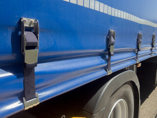 Detail of a load straps on a truck curtain wall