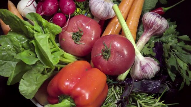 Vegetarian healthy food, vegetables:  salad, tomatoes ,peppers and others on a rotating plate