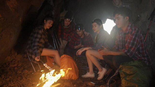 Asian friend groups having fun camping in cave  holiday, wild adventure. concept for holiday and Travel for your work.