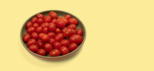 cherry tomatoes with water drops in ceramic bowl