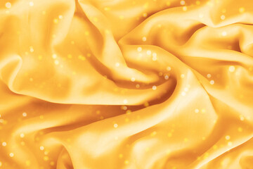 Silk yellow texture, abstract background luxury fabric with wavy folds, christmas background.