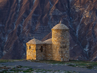 Fototapeta na wymiar Stone mosque on the background of the mountains. Hunzah. Dagestan.