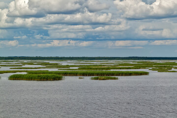 Sky in the clouds, vegetation on the river