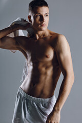 a man with an inflated torso holding a towel on his shoulder bodybuilder fitness 