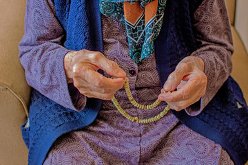 old muslim woman and rosary worshiping Allah.