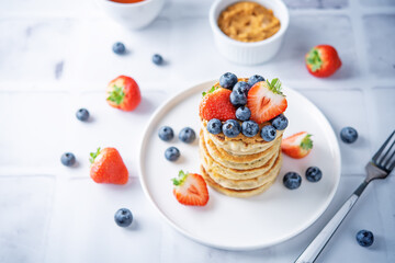 Banana pancakes with strawberries and blueberries